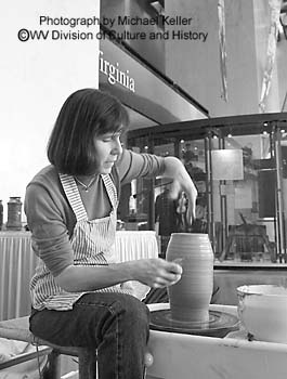 Marcia Springston throwing pots in Great Hall of Cultural Center